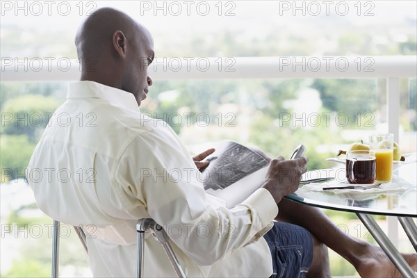 African American man reading magazine