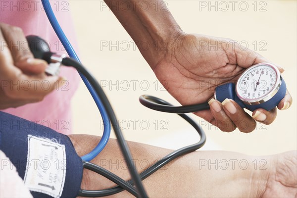 Nurse taking senior's blood pressure