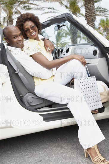 African American couple sitting in convertible