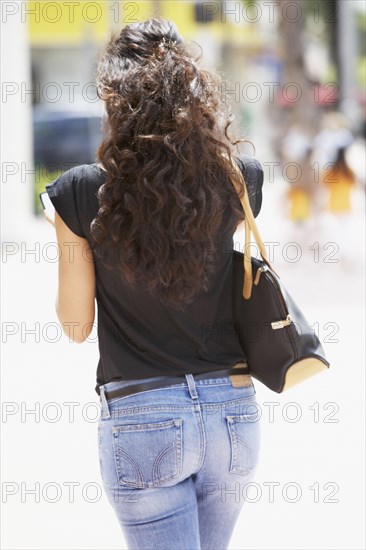 Cuban ethnicity woman carrying purse