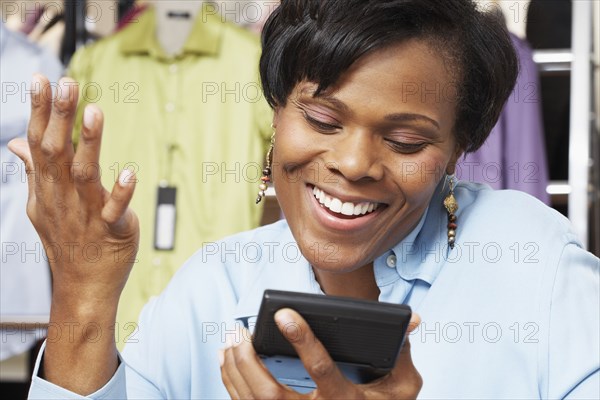 African woman looking at calculator