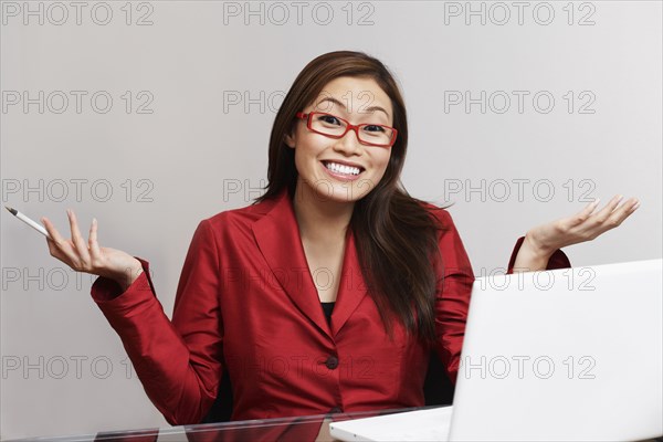 Asian businesswoman shrugging shoulders