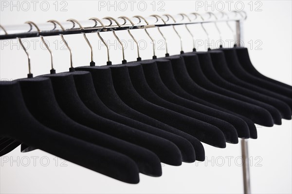 Row of empty clothing hangers on rack