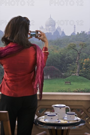 Woman taking photograph of the Taj Mahal