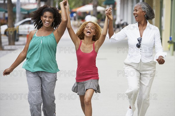 Multi-generational women holding hands