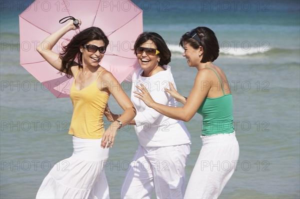 Mother and sisters playing on beach