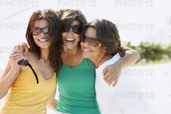 Mother and sisters hugging