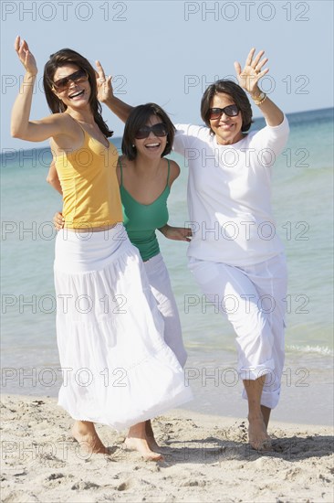 Mother and sisters playing on beach