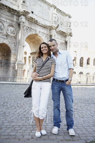 Tourist couple hugging near ruins