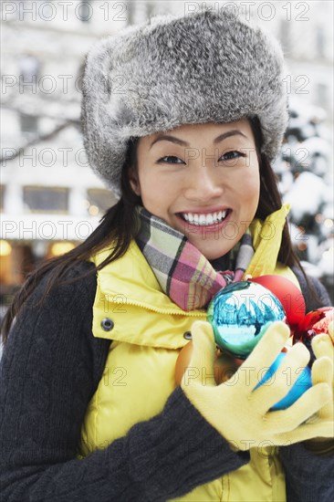 Korean woman carrying Christmas ornaments