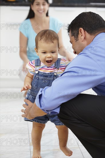 Hispanic father playing with daughter
