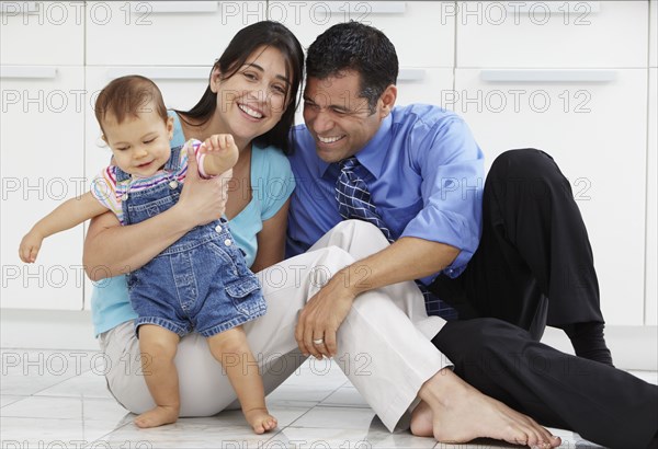 Hispanic family sitting on floor