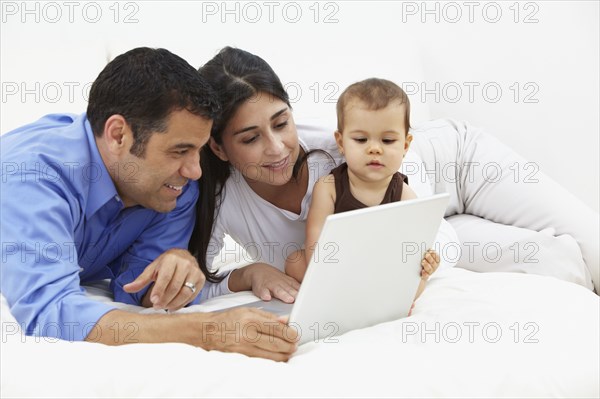 Hispanic family looking at laptop