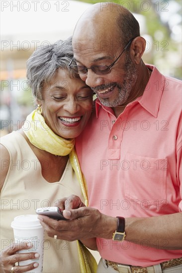 African couple using cell phone