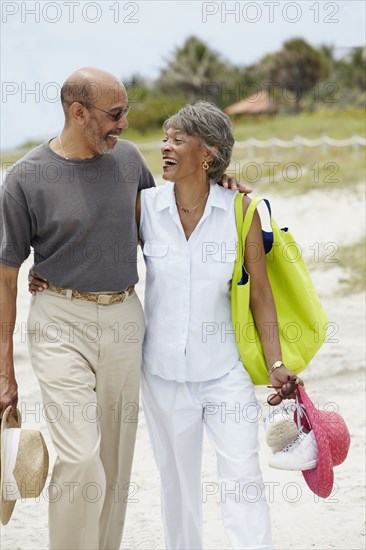 African couple walking on beach