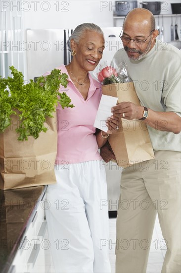 African couple grocery shopping