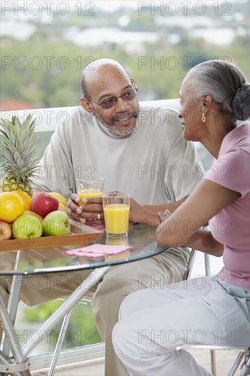 African couple drinking orange juice