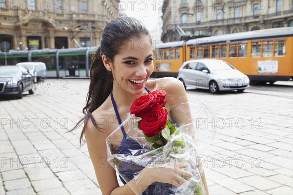 Brazilian woman holding red roses