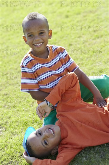 African American boys playing in grass