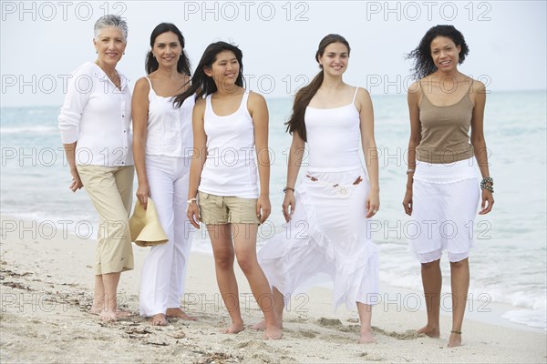 Diverse women standing on beach together