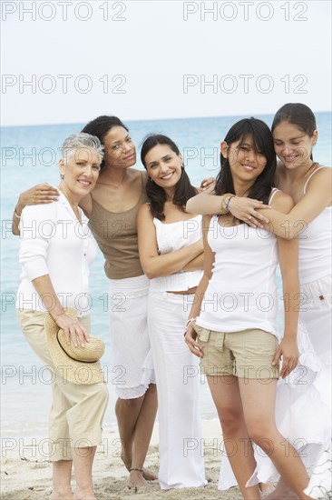 Diverse women standing on beach together