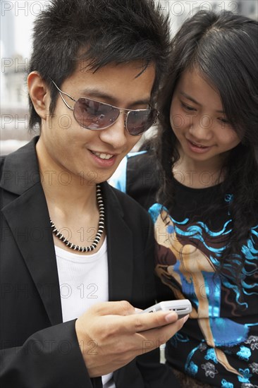 Chinese couple looking at cell phone