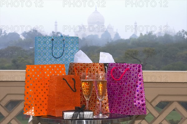 Group of luxurious shopping bags on table with Champagne