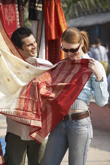 Customer looking at fabric in market