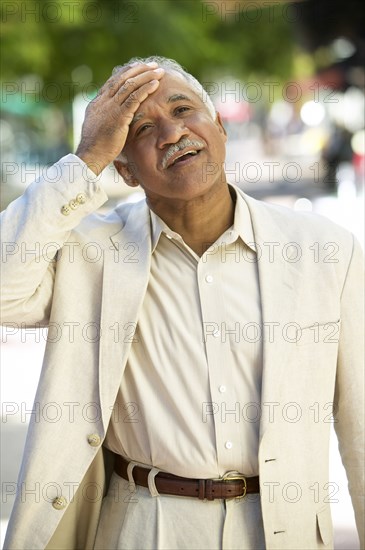 Relieved mixed race man standing outdoors