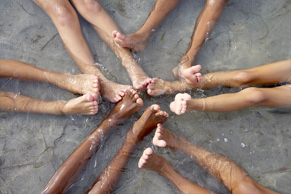 Children with feet together in water