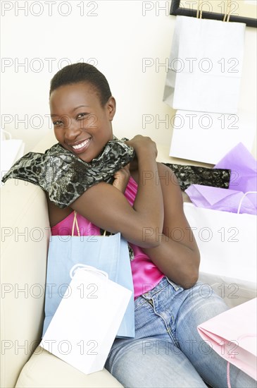 Excited African American woman with shopping bags