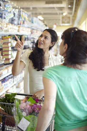 Women talking together in grocery store