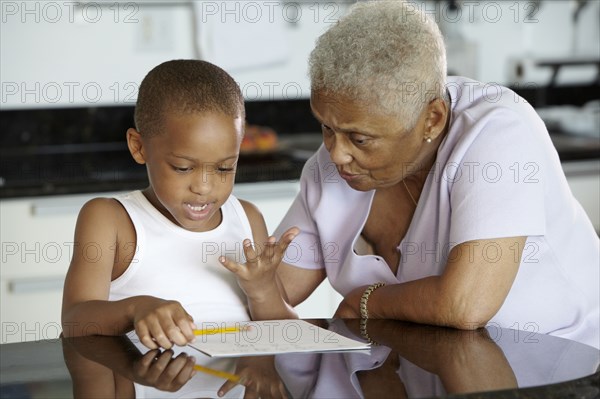 African American grandmother helping grandson with homework