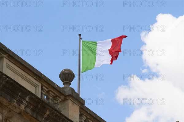 Italian flag fluttering on rooftop