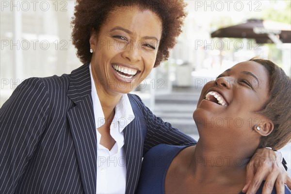 Laughing African American mother and daughter