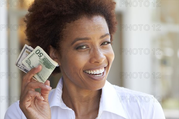 African American woman holding 50 dollar bill