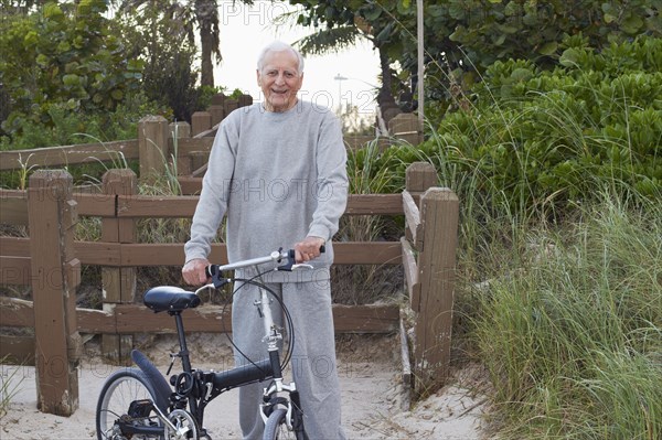 Caucasian man standing with bicycle