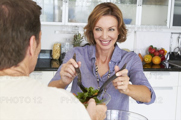 Caucasian couple eating salad