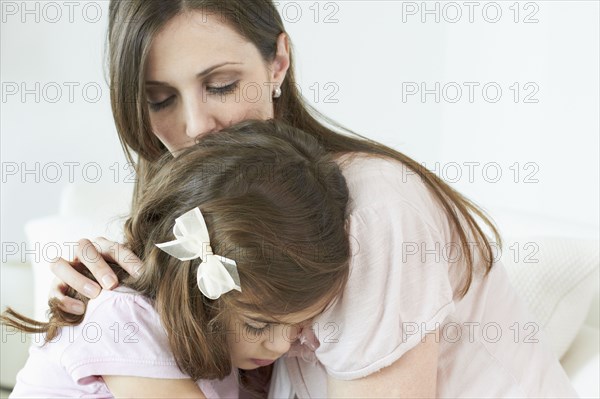 Caucasian woman comforting daughter