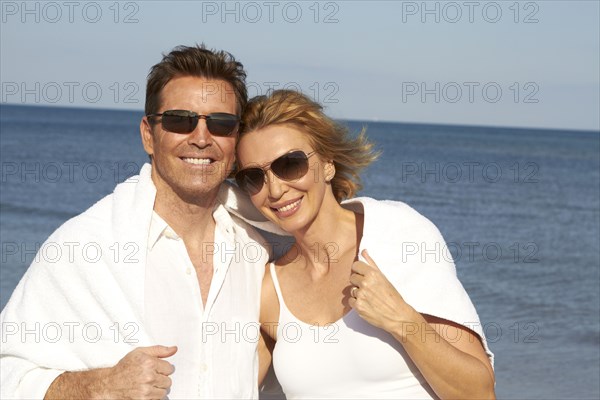 Caucasian couple smiling on beach