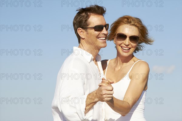 Caucasian couple dancing outdoors