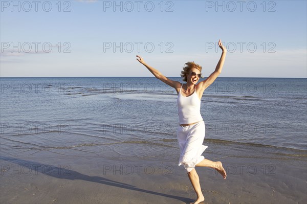 Caucasian woman playing on beach