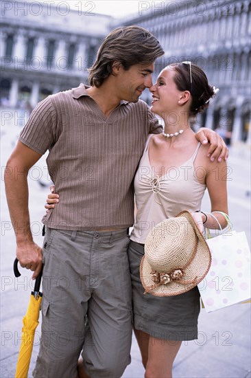 Caucasian couple hugging in St. Mark's Square