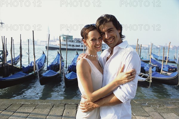 Couple hugging on urban canal front