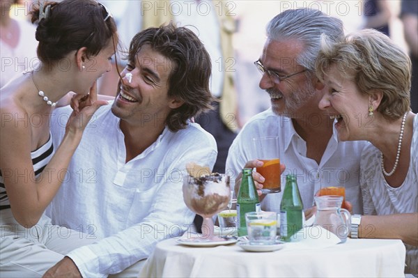 Couples eating together at sidewalk cafe