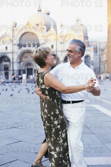 Senior couple dancing in St. Mark's Square