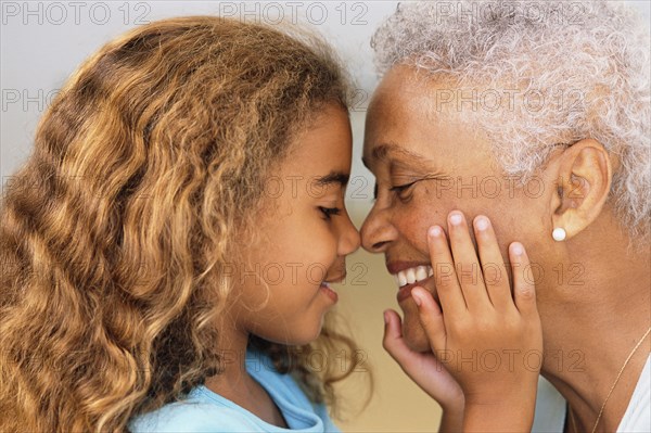 Senior woman and granddaughter touching noses