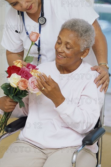 Senior patient getting flowers in hospital