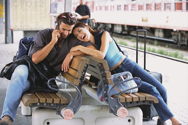 Couple relaxing at train station