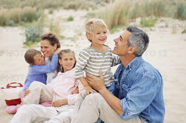 Caucasian family having picnic on beach